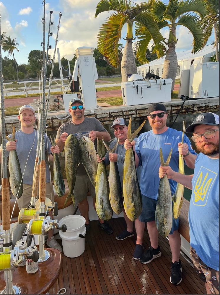 Group of friends with a mahi catch at the dock